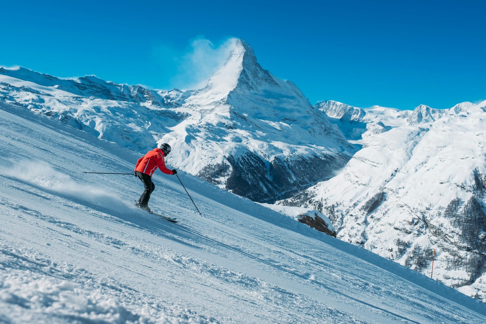 Skiers enjoying a run with the Matterhorn in the background.