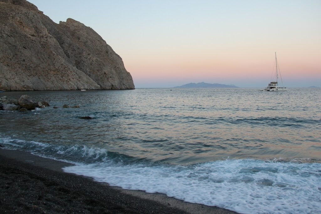 Black Sand Beaches: A picture of Perissa beach with its black sand.