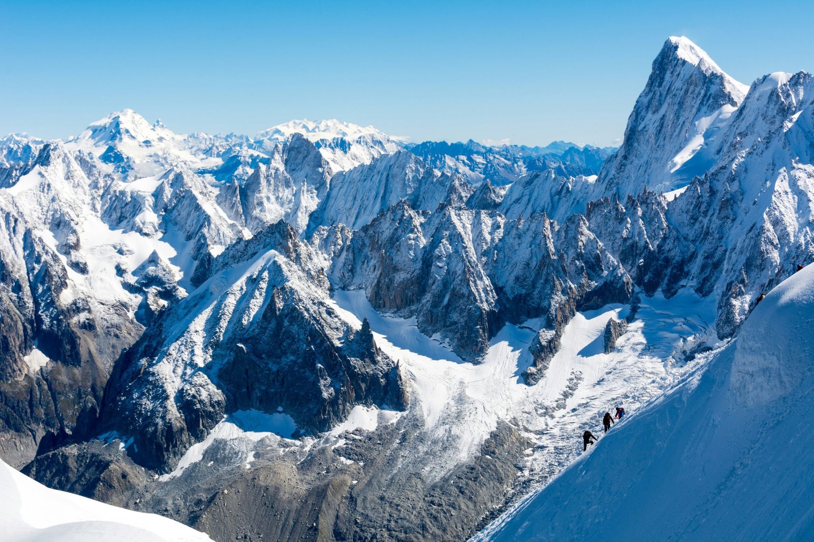 A breathtaking shot of Mont Blanc with skiers on the slopes.