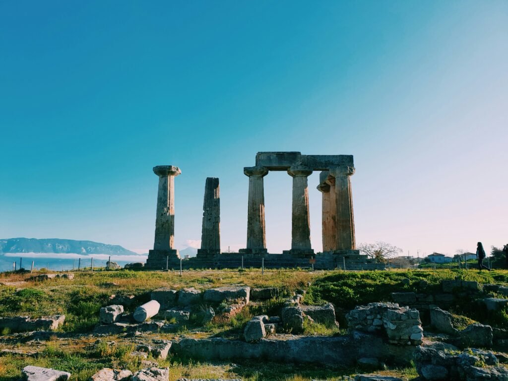 Delphi: Image of the Temple of Apollo with mountainous scenery.